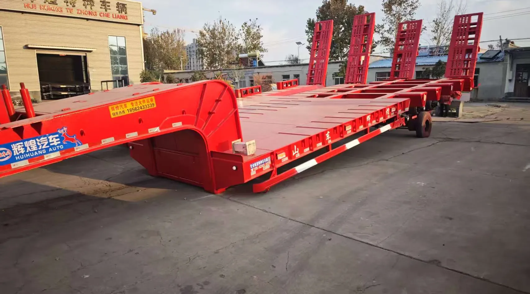 Red huihuang lowbed semi-trailer in the factory yard